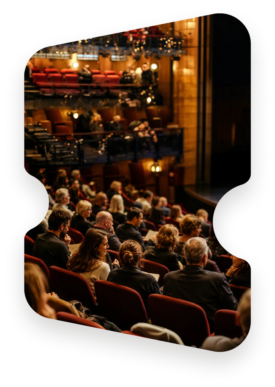 A full auditorium seen from among the audience