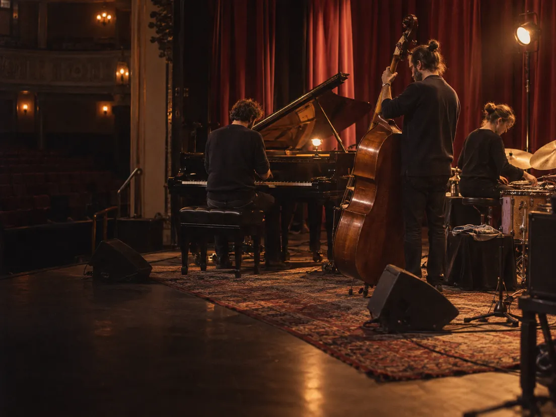 Musicians setting up on a lit stage